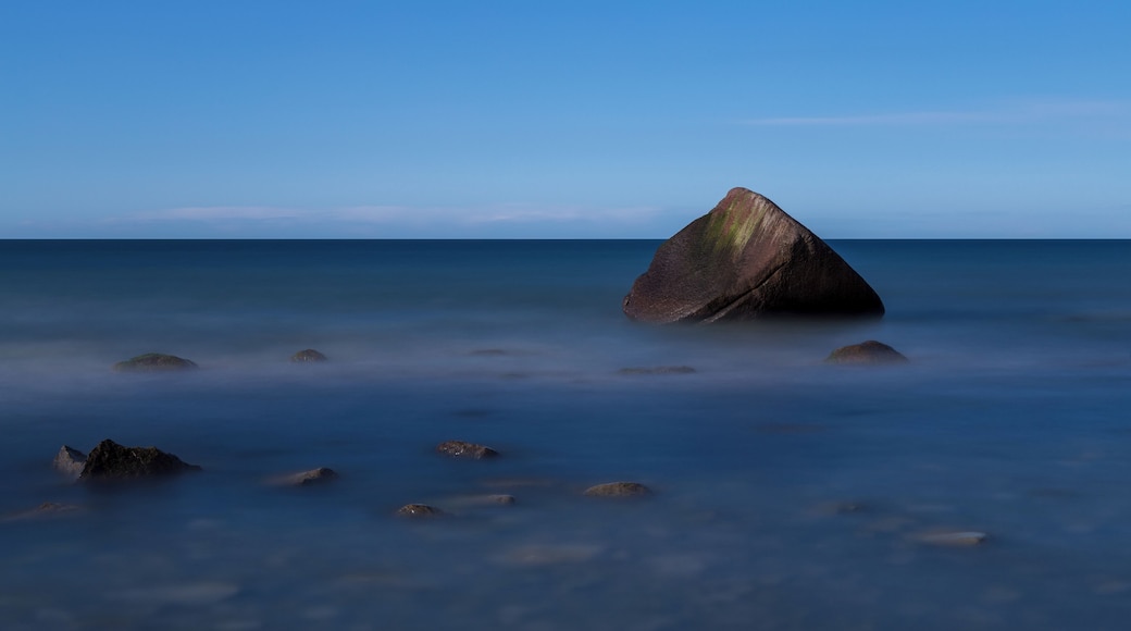The so called Schwanenstein, a glacial erratic near the village of Lohme on the island of Rügen, Germany. On 13 February 1956, a sad story linked to the stone happened when three boys of the village of Lohme were playing at the shore of the frozen sea. Suddenly the weather changed and a storm broke the ice. The boys saved themselves on the stone. As the wind became a hurricane, local fishermen and border guards tried to save them, but they failed due to the heavy storm. The next morning, when the weather had calmed, the bodies of the three boys were recovered from the stone.