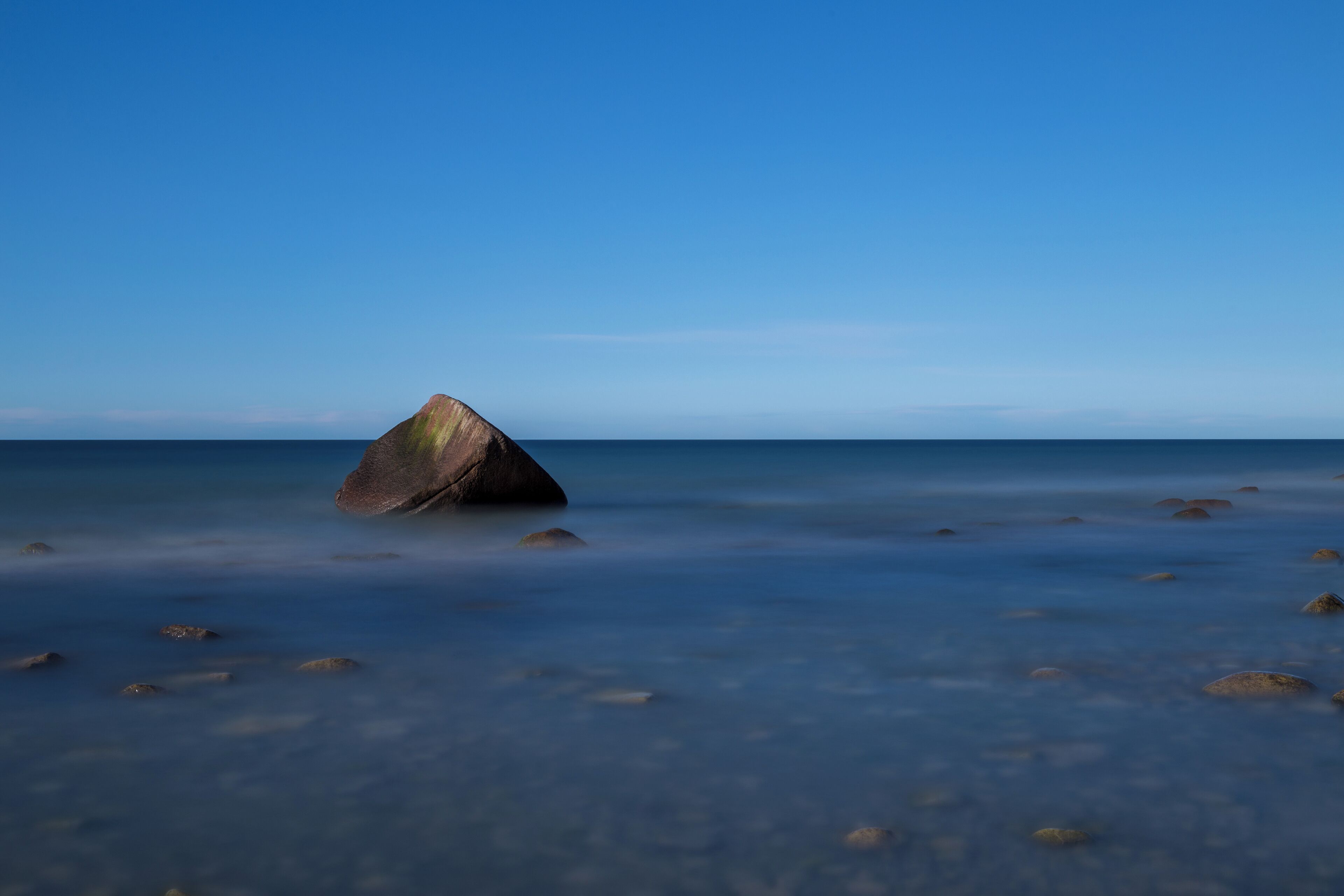 The so called Schwanenstein, a glacial erratic near the village of Lohme on the island of Rügen, Germany. On 13 February 1956, a sad story linked to the stone happened when three boys of the village of Lohme were playing at the shore of the frozen sea. Suddenly the weather changed and a storm broke the ice. The boys saved themselves on the stone. As the wind became a hurricane, local fishermen and border guards tried to save them, but they failed due to the heavy storm. The next morning, when the weather had calmed, the bodies of the three boys were recovered from the stone.