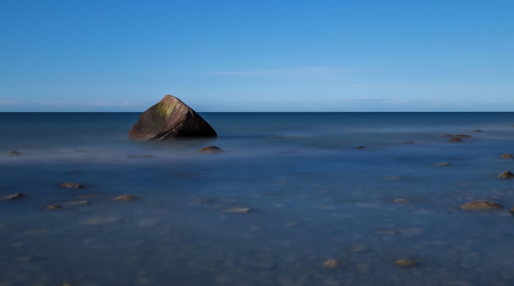 The so called Schwanenstein, a glacial erratic near the village of Lohme on the island of Rügen, Germany. On 13 February 1956, a sad story linked to the stone happened when three boys of the village of Lohme were playing at the shore of the frozen sea. Suddenly the weather changed and a storm broke the ice. The boys saved themselves on the stone. As the wind became a hurricane, local fishermen and border guards tried to save them, but they failed due to the heavy storm. The next morning, when the weather had calmed, the bodies of the three boys were recovered from the stone.