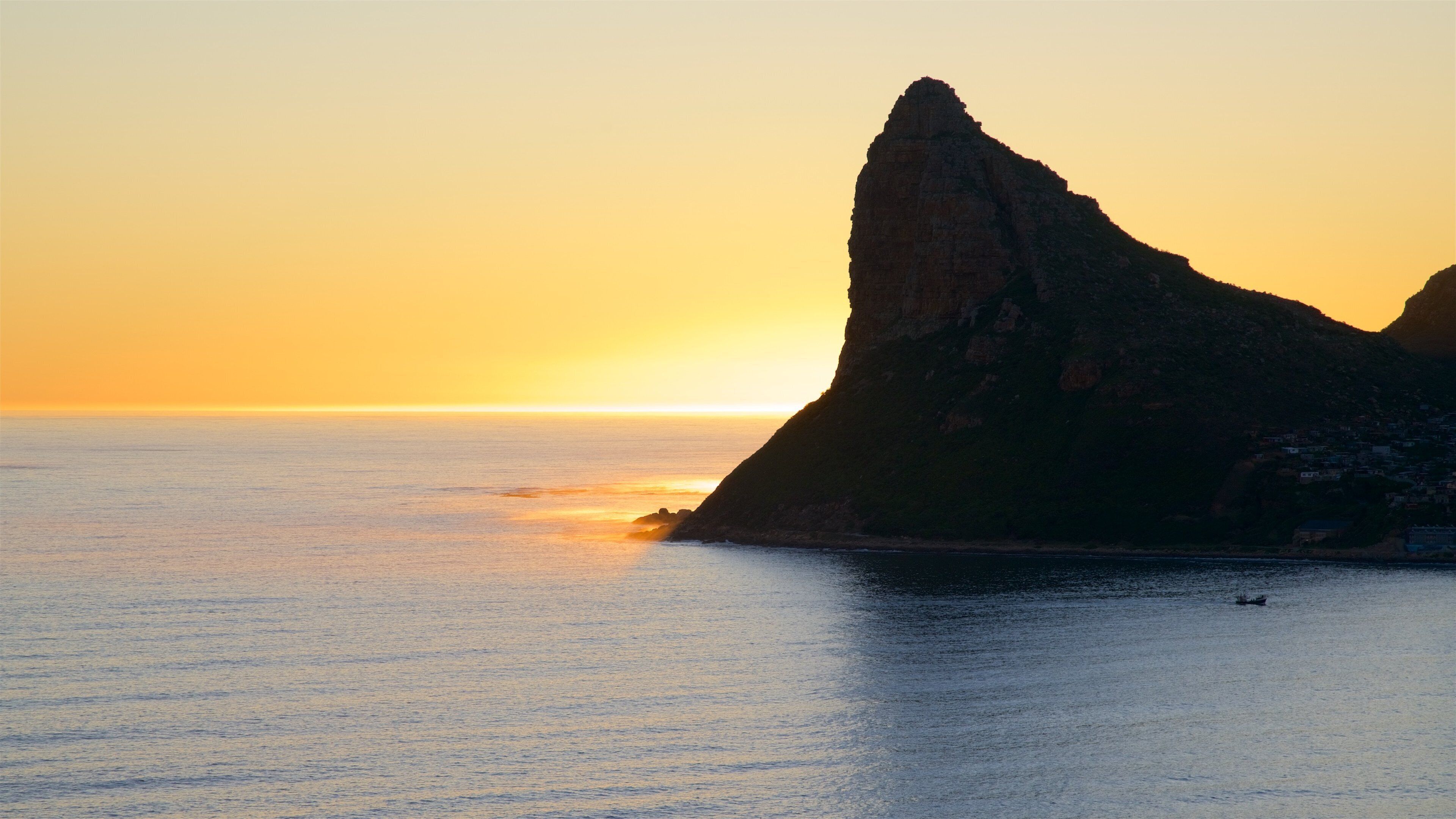 Chapmans Peak que inclui litoral rochoso e um pôr do sol