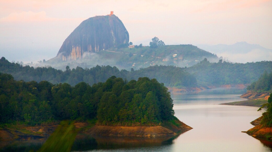 Rock of Guatape showing mountains, tranquil scenes and a river or creek