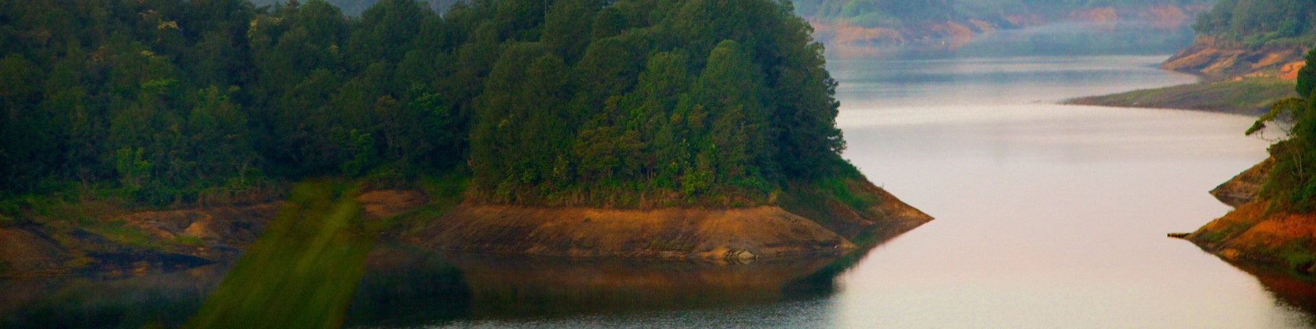 Rock of Guatape featuring landscape views, mist or fog and a river or creek