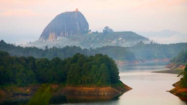 Rock of Guatape showing mist or fog, tranquil scenes and a river or creek