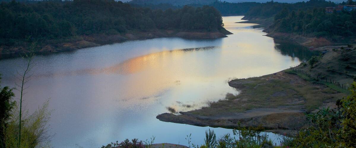 Rock of Guatape showing a sunset, landscape views and forests