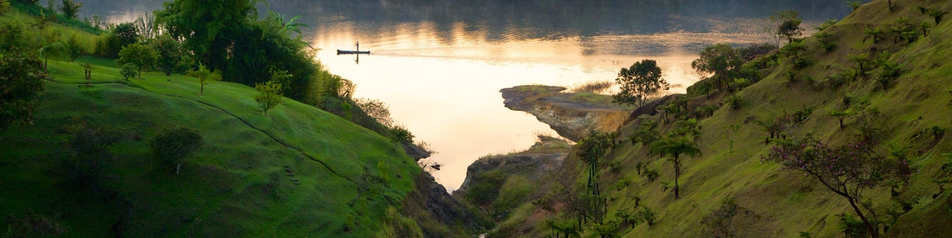 Rock of Guatape which includes tranquil scenes, forests and a river or creek