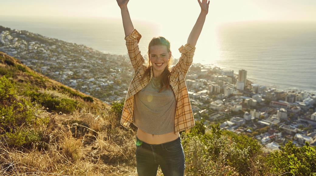 South Africa, Cape Town, Signal Hill, portrait of happy young woman above the city