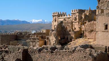 Ruins of Glaoui kasbah at Telouet, with snow capped High Atlas Mountains in distance, Telouet, Morocco