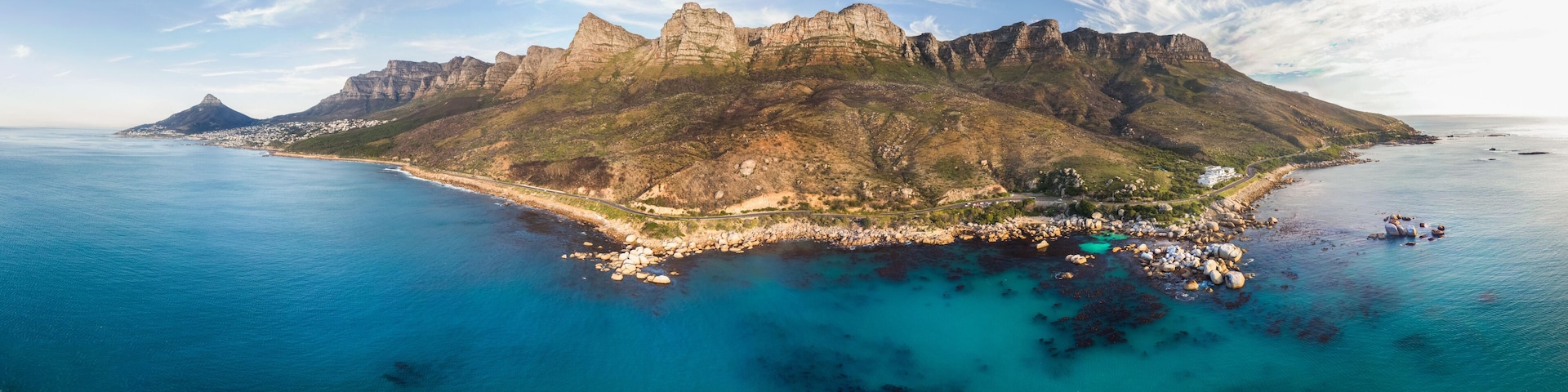 Panoramic aerial view of scenic beach road along Atlantic Ocean going past Twelve Apostles and Lions Head, Victoria Road, Oudekraal, Cape Town, South Africa