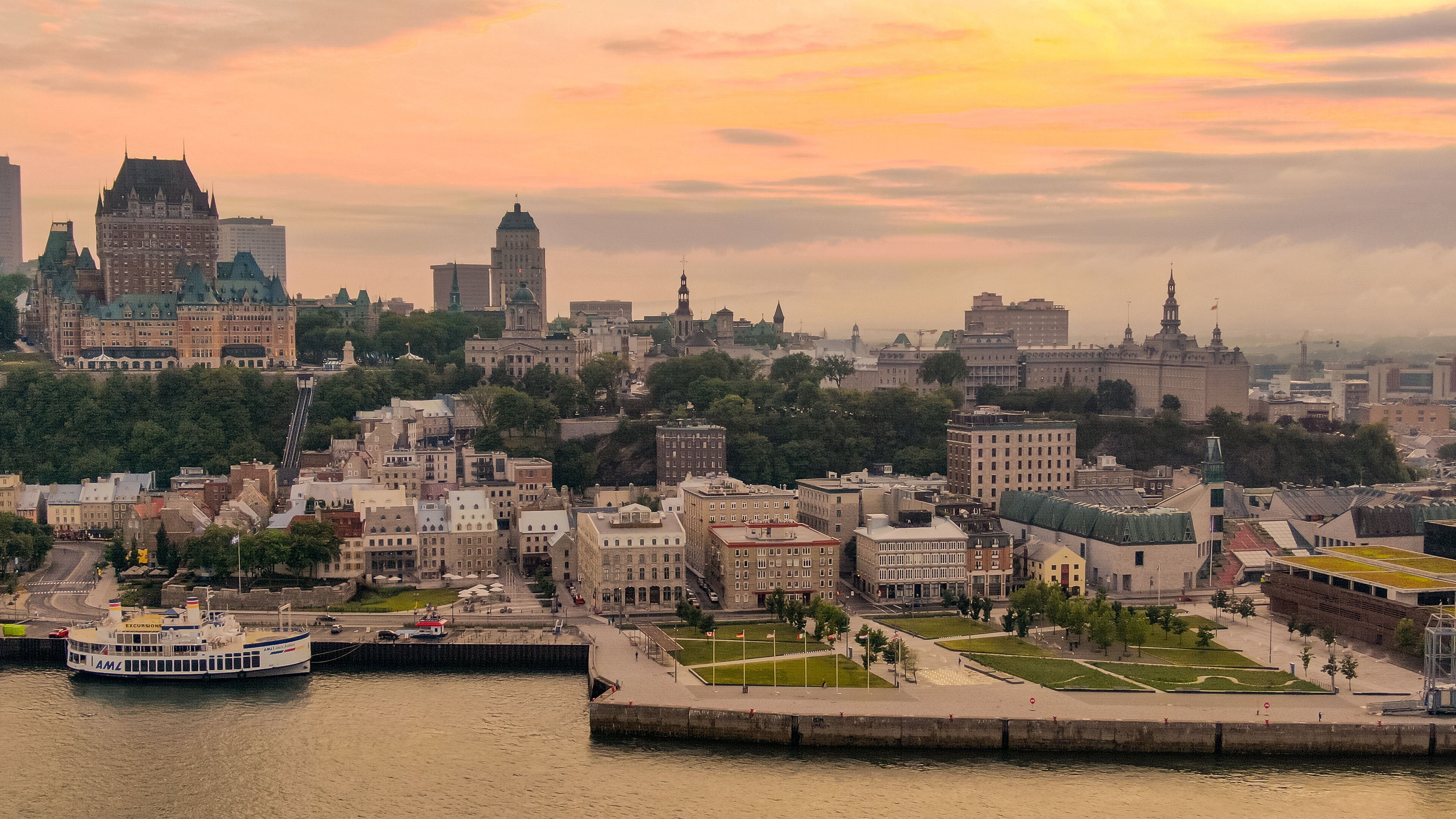 La Cite-Limoilou showing a sunset, a city and a bay or harbor