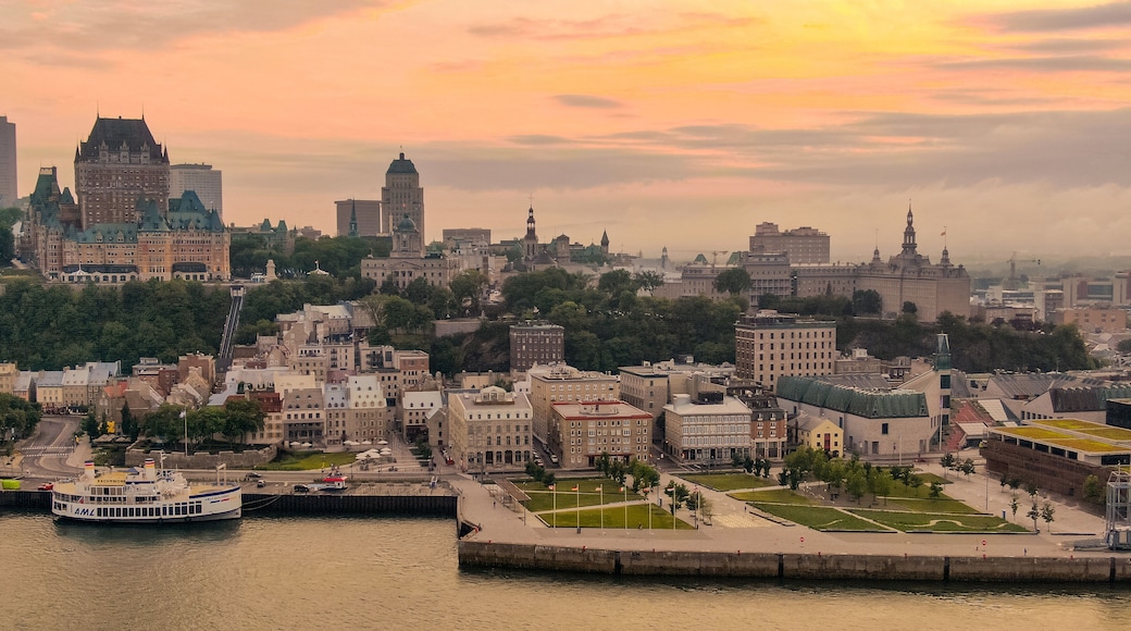 La Cite-Limoilou showing a sunset, a city and a bay or harbor