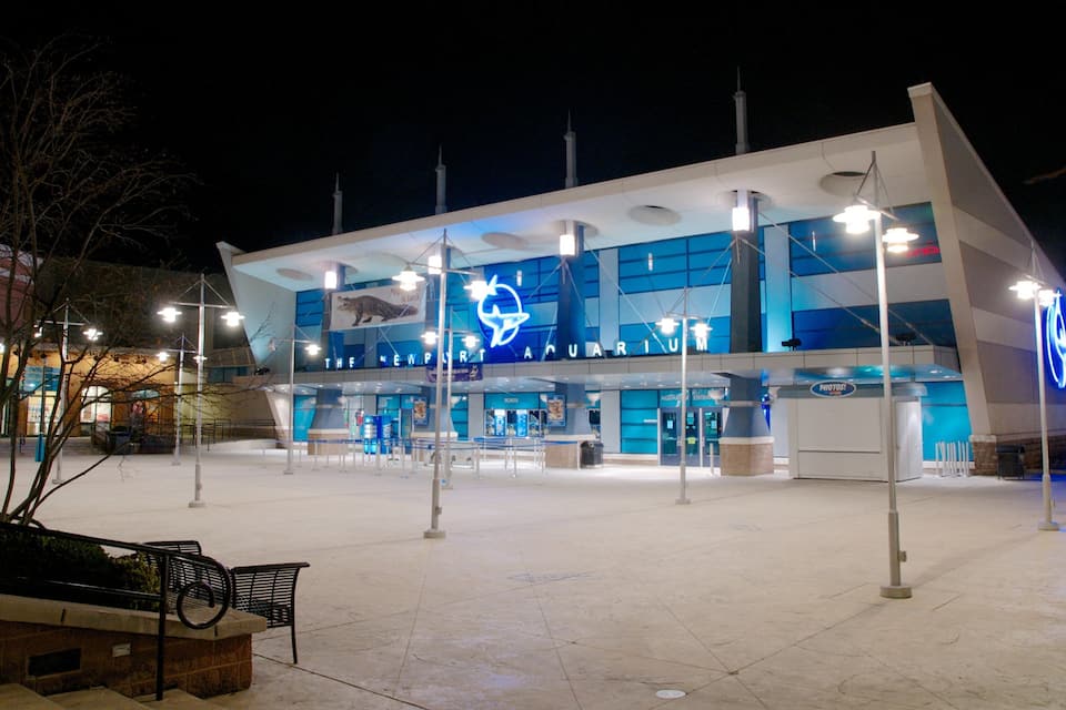 A modern building with a blue sign reading "The Newport Aquarium."