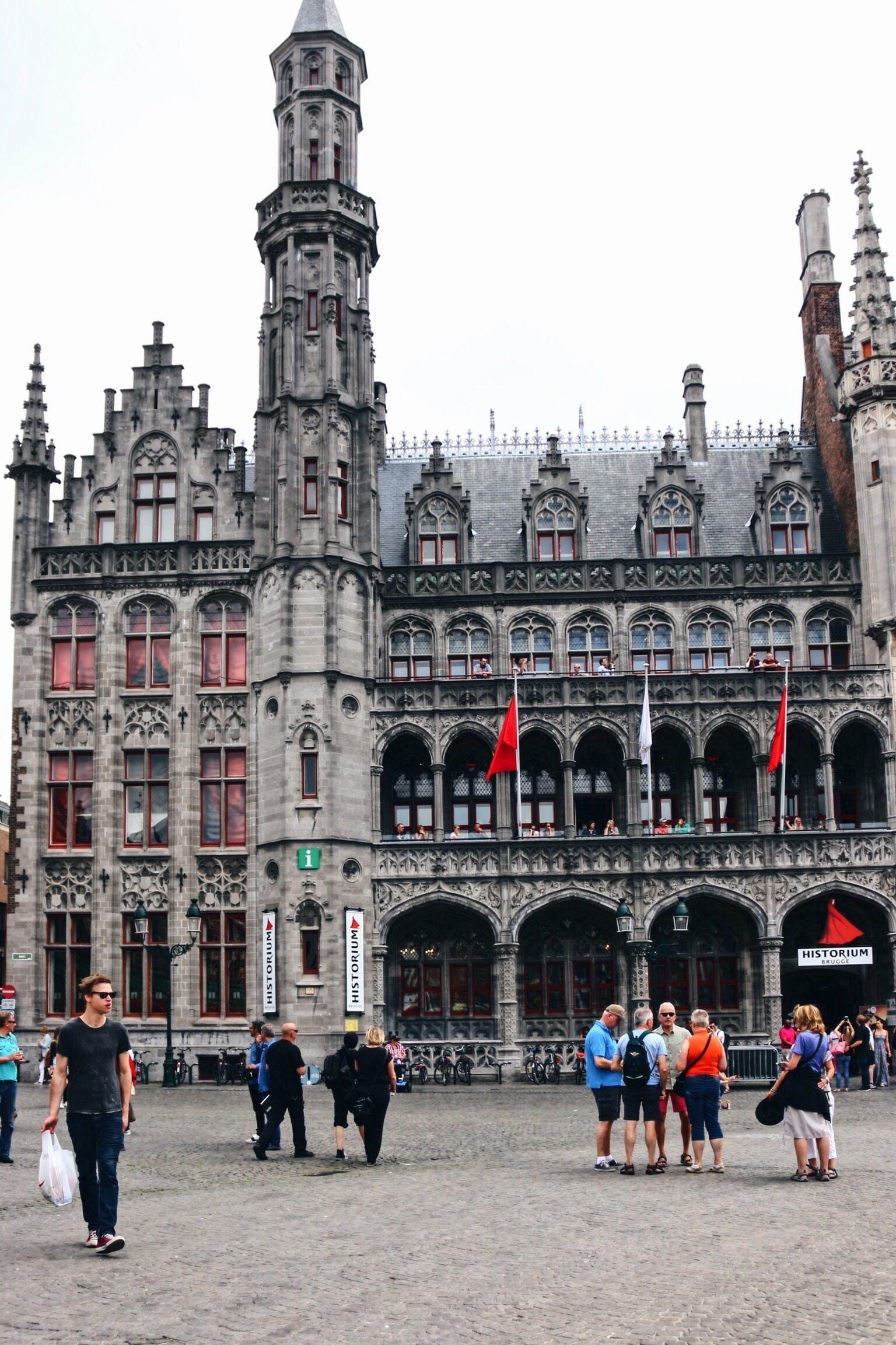 A historic building with intricate architecture and flags.