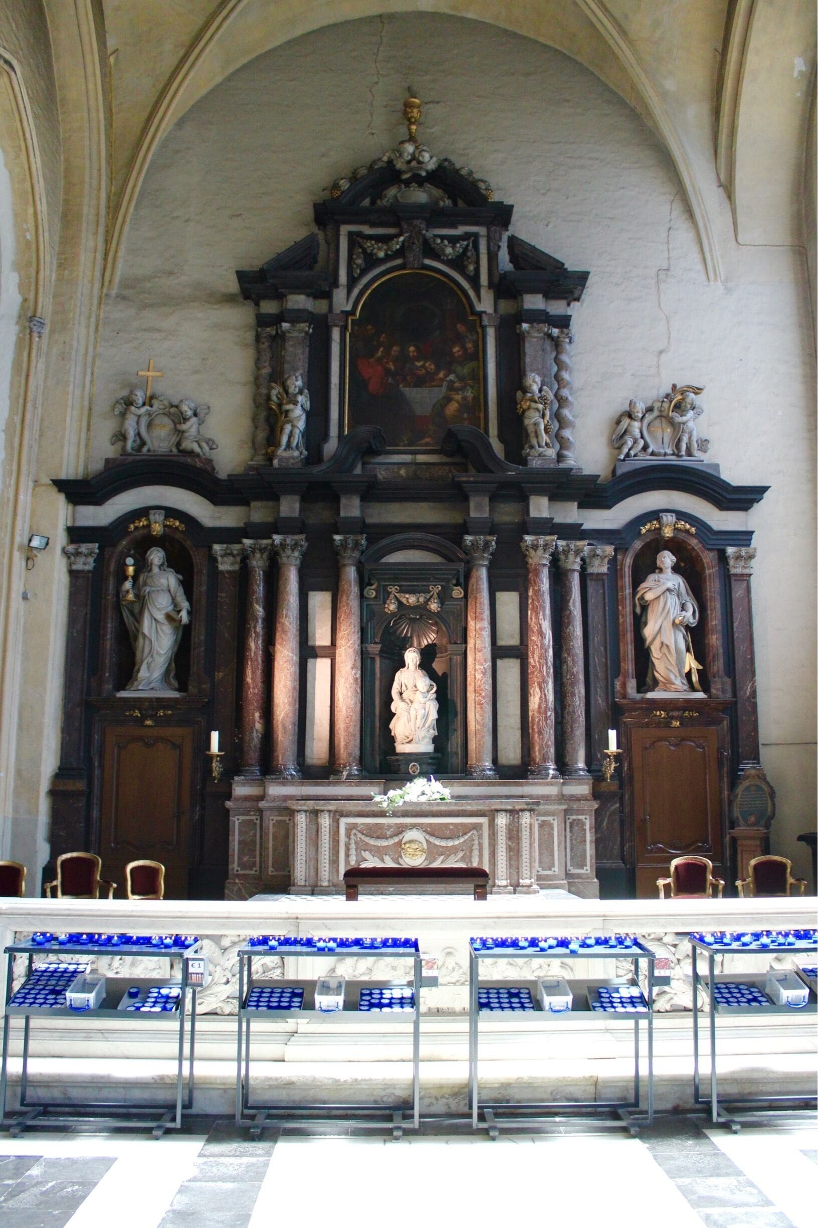The Madonna of Bruges is a marble sculpture by Michelangelo of Mary with the Child Jesus.

Michelangelo's depiction of the Madonna and Child differs significantly from earlier representations of the same subject, which tended to feature a pious Virgin smiling down on an infant held in her arms. Instead, Jesus stands upright, almost unsupported, only loosely restrained by Mary's left hand, and appears to be about to step away from his mother. Meanwhile, Mary does not cling to her son or even look at him, but gazes down and away. It is believed the work was originally intended for an altar piece. If this is so, then it would have been displayed facing slightly to the right and looking down. The early 16th-century sculpture also displays the High Renaissance Pyramid style frequently seen in the works of Leonardo da Vinci during the late 1400s.

Madonna and Child shares certain similarities with Michelangelo's Pietà, which was completed shortly before – mainly, the chiaroscuro effect and movement of the drapery. The long, oval face of Mary is also reminiscent of the Pietà.
The work is also notable in that it was the only sculpture by Michelangelo to leave Italy during his lifetime. It was bought by Giovanni and Alessandro Moscheroni (Mouscron), from a family of wealthy cloth merchants in Bruges, then one of the leading commercial cities in Europe. The sculpture was sold for 4,000 florins.

The sculpture was removed twice from Belgium after its initial arrival. The first was in 1794, after French Revolutionaries had conquered the Austrian Netherlands during the French Revolutionary Wars; the citizens of Bruges were ordered to ship it and several other valuable works of art to Paris. It was returned after Napoleon's final defeat at Waterloo in 1815. The second removal was in 1944, during World War II, with the retreat of German soldiers, who smuggled the sculpture to Germany enveloped in mattresses in a Red Cross truck.[1] It was discovered a year later in Altaussee/Austria within a salt mine and again returned. It now sits in the Church of Our Lady in Bruges, Belgium. This is part of the fact-based movie The Monuments Men.

The Church of Our Lady in Bruges, Belgium, dates mainly from the 13th, 14th and 15th centuries.

Bruges is the capital and largest city of the province of West Flanders in the Flemish Region of Belgium, in the northwest of the country.

The historic city centre is a prominent World Heritage Site of UNESCO.

 Along with a few other canal-based northern cities, such as Amsterdam, it is sometimes referred to as The Venice of the North. Bruges has a significant economic importance thanks to its port and was once one of the world's chief commercial cities.  Bruges is well known as the seat of the College of Europe, a university institute for European studies.

#LIFEATEXPEDIA  #TRAVEL #HILLBILLYINPARIS #BRUGES