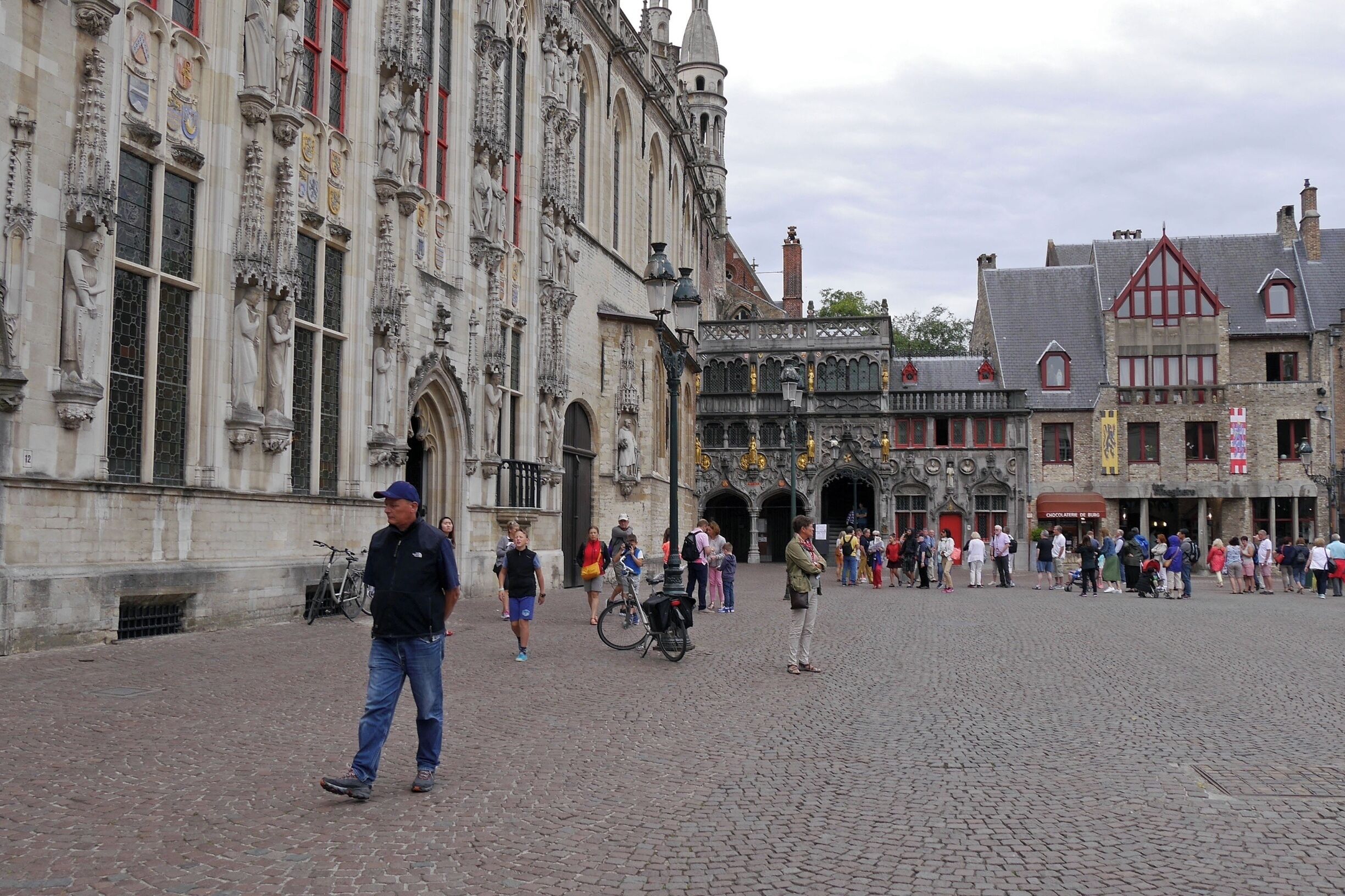 Bruges City Hall to the left & the Gothic exterior of the Basilica of Holy Blood with gilded figures in the corner of this charming square.
Bruges’ City Hall dates from 1376 and is one of the oldest in the Low Countries. It is from here that the city has been governed for more than 600 years.
Basilica of the Holy Blood dates from the 12th century.