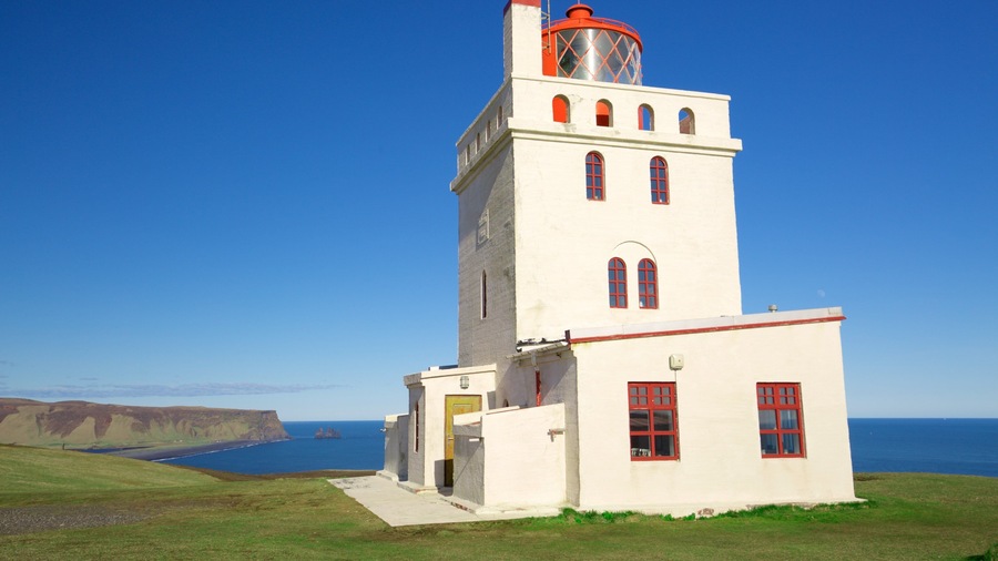 Dyrholaey which includes a lighthouse and general coastal views