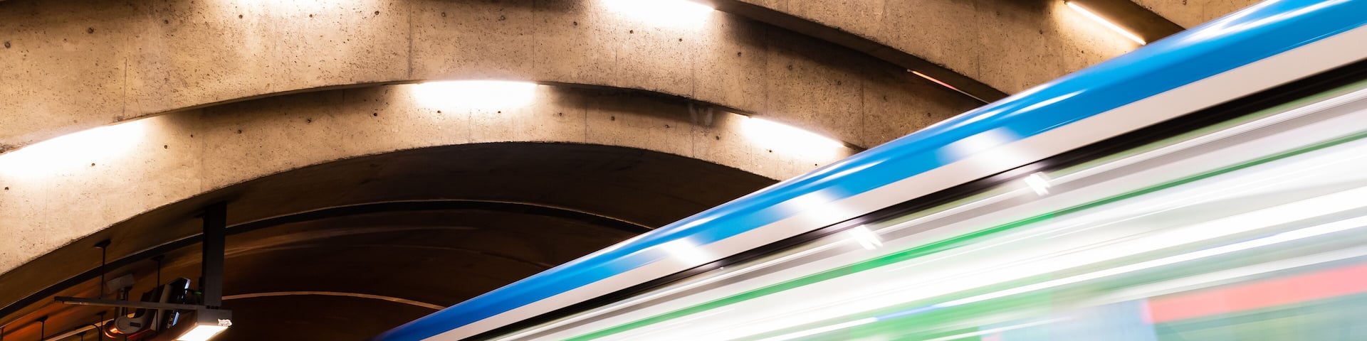 Long exposure photography of a subway train in motion in a station
