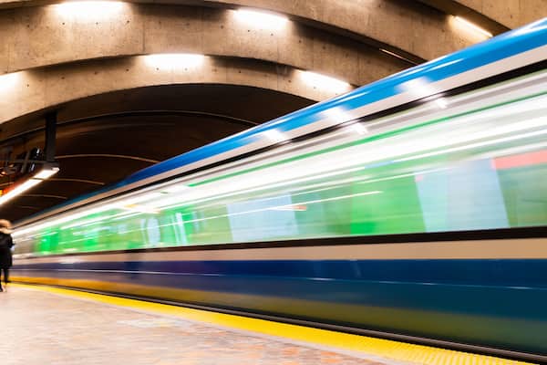 Long exposure photography of a subway train in motion in a station
