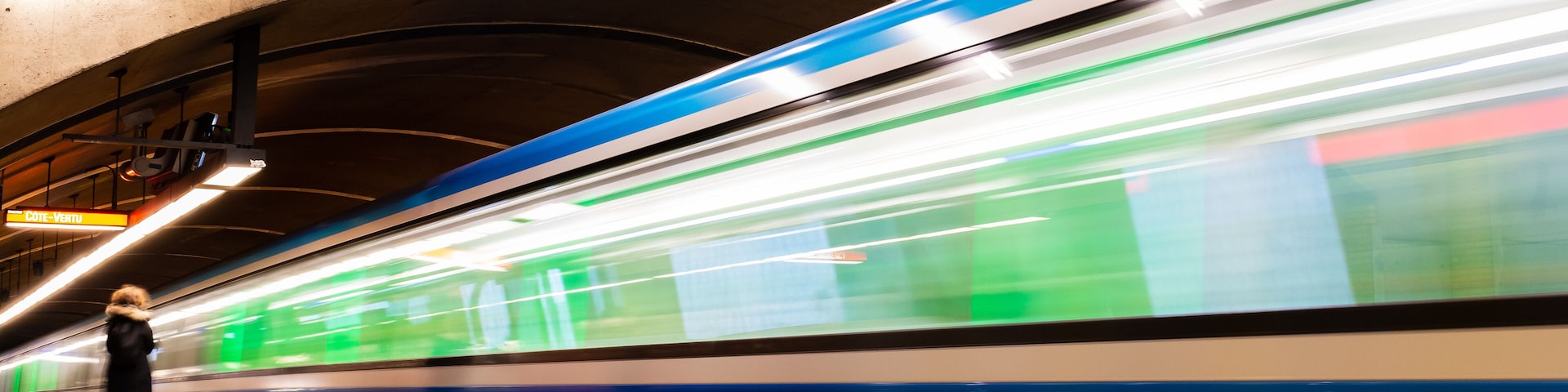 Long exposure photography of a subway train in motion in a station