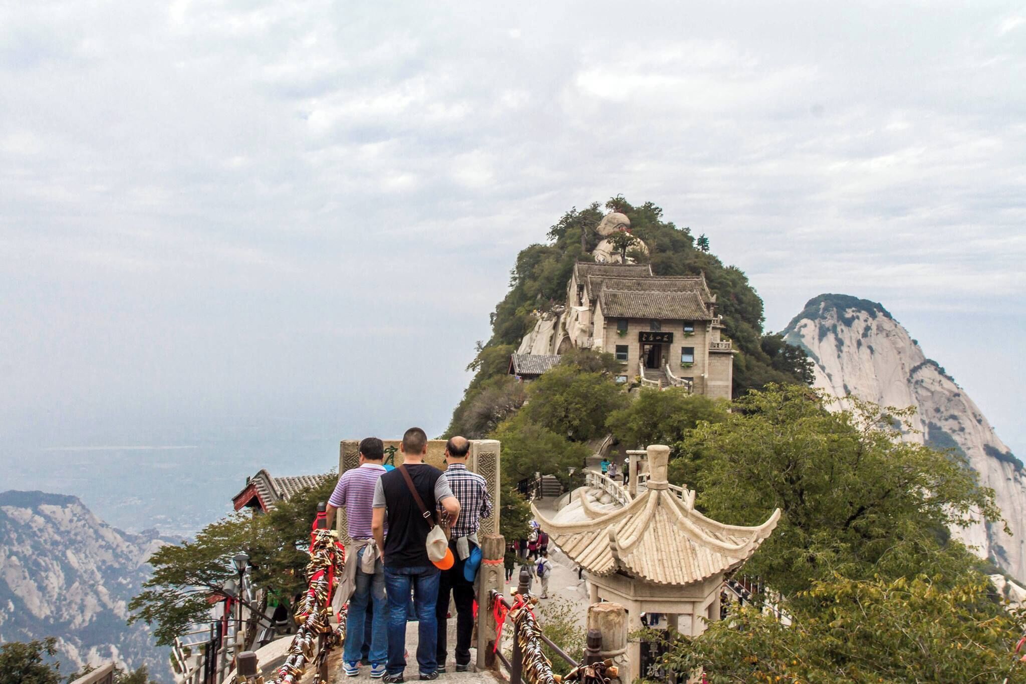 Huashan is about 120 km east of Xian, about 2/12 to 3 hrs ride from the city. 

Five peaks make up this mountain, namely : Cloud Terrace Pea (North Peak, 1610 m), Jade Maiden Peak (Middle Peak, 2040 m ), Sunrise Peak (East Peak, 2100 m), Lotus Peak (West Peak , 2040 m), and Landing Wild Goose Peak (South Peak, 2160 m ).

This mountain has steep, vertical cliffs and plunging ravines . The views are breathtaking but definitely not for the acrophobic and the faint-hearted.  
We took the cable car to The North Peak, was the most amazing cable car ride i'd ever been on. It's very steep and very high ! 

I wonder how some people manage to hike up the mountain, I take my hat off to them.

#LikeALocal