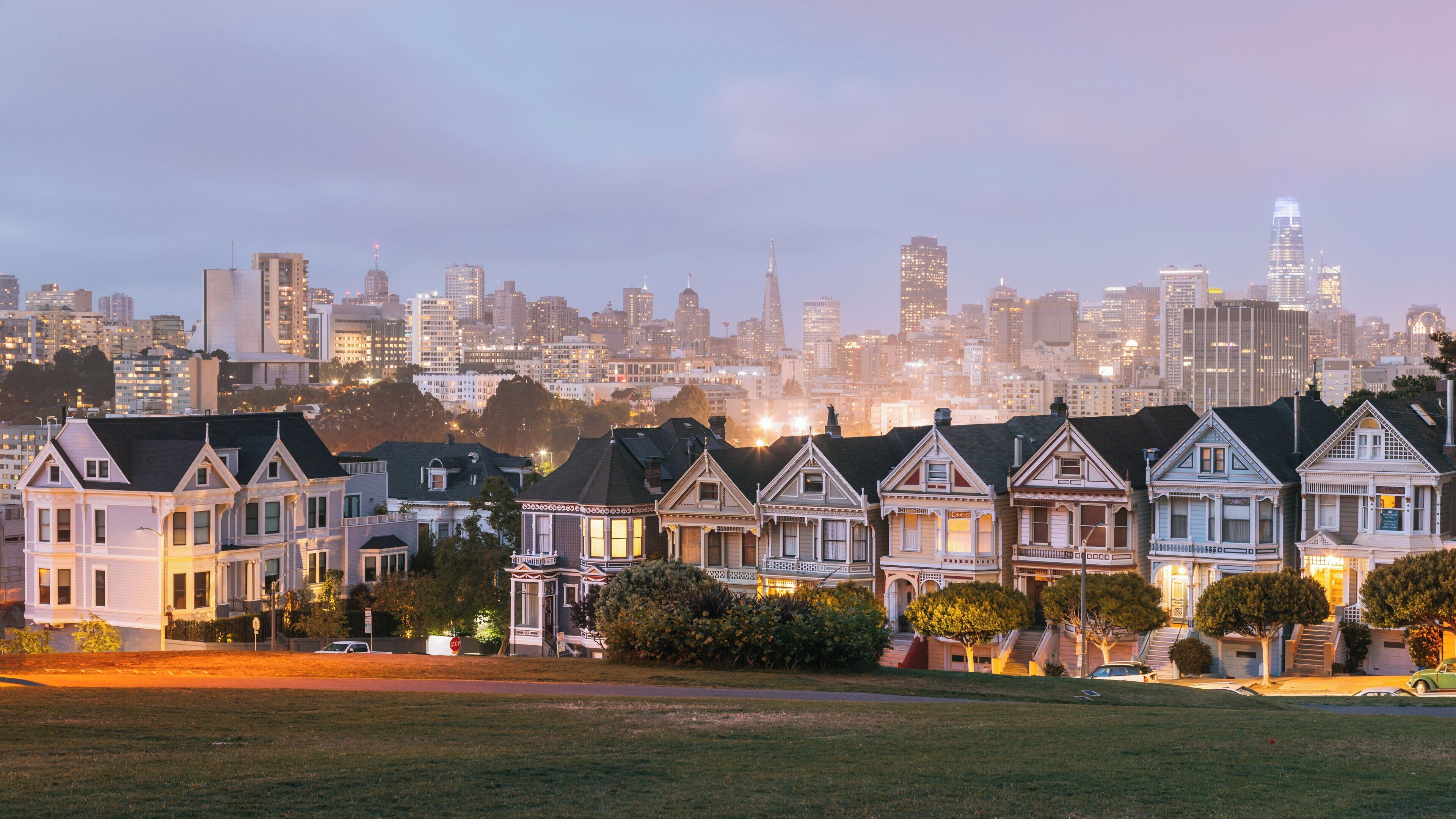 Vibrant Painted Ladies in Western Addition showcasing San Francisco's skyline during sunset