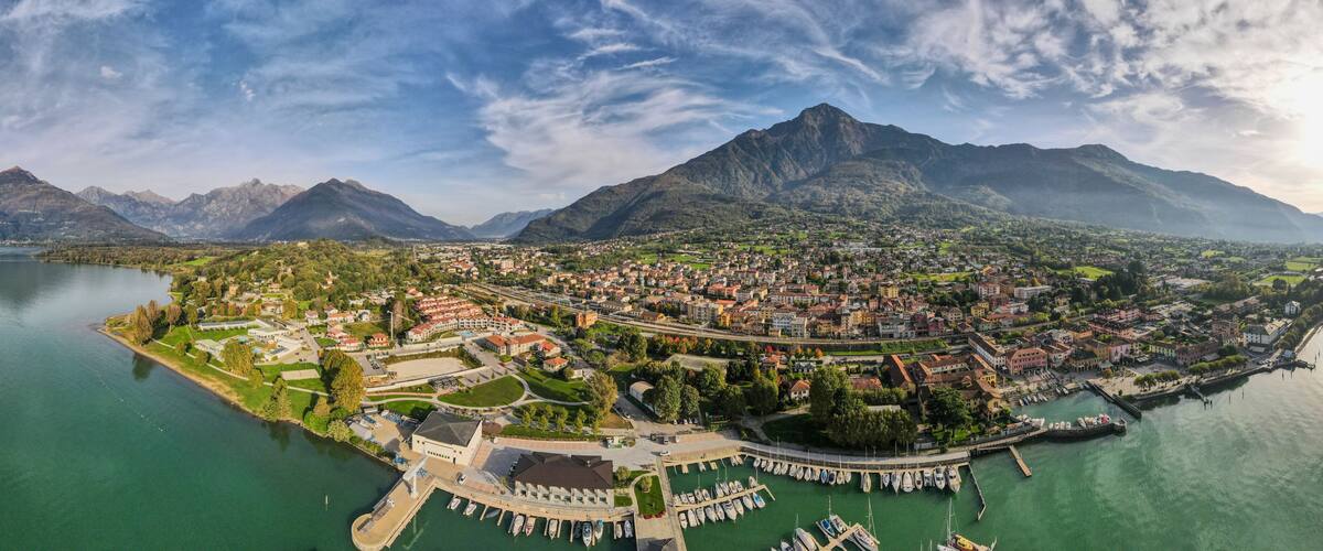A coastal town with a marina, surrounded by mountains and a lake.