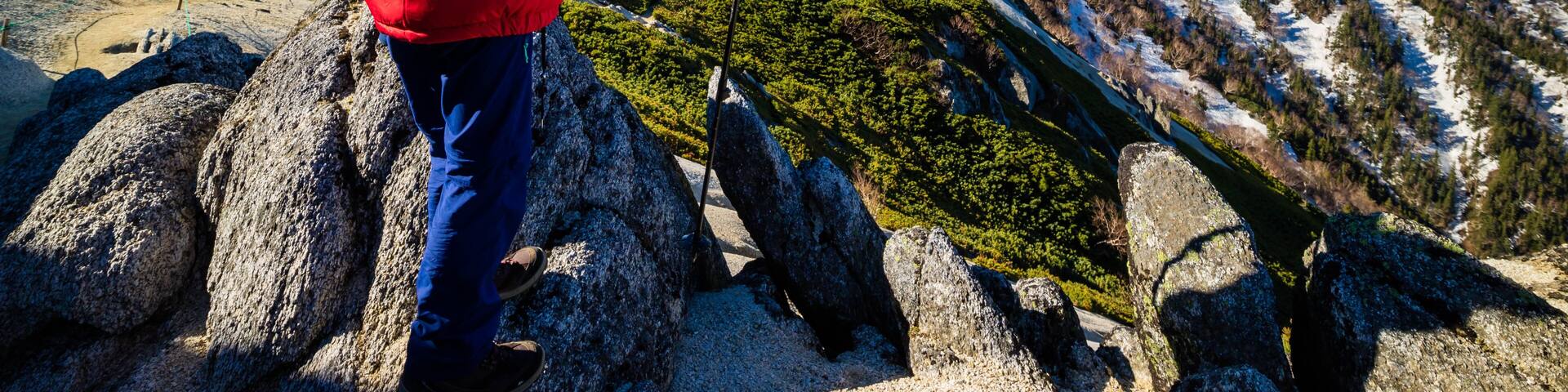 Successful woman at top of Mount Tsubakuro Dake, famous trekking mountain in Azumino, Nagano, Japan. It is situated in Japan's Hida Mountains or Japan Alps.