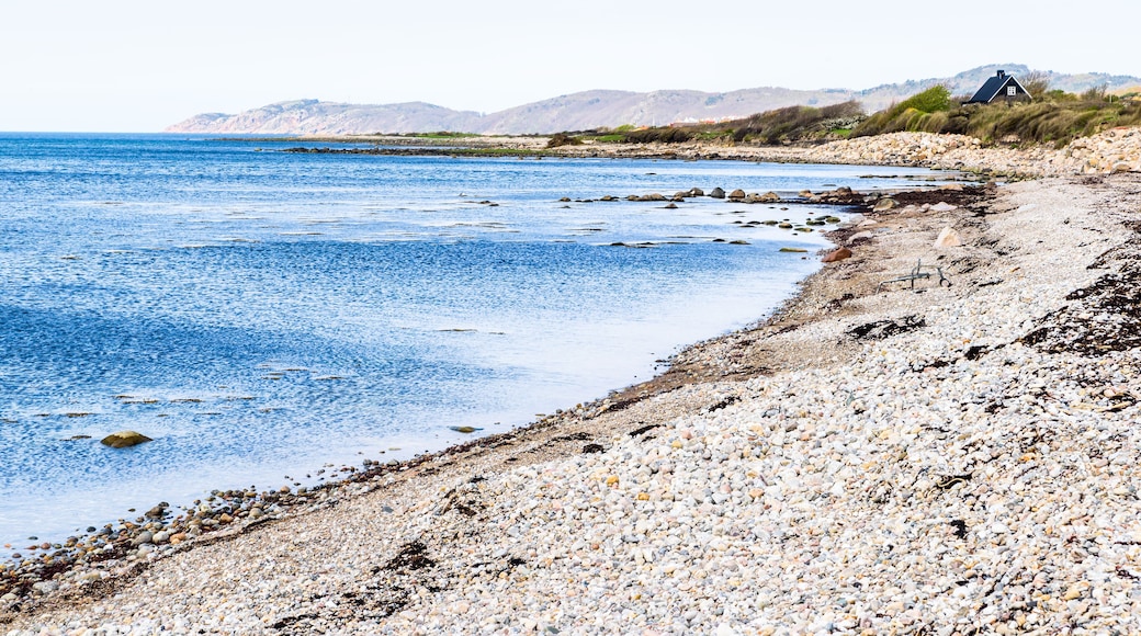Coastal landscape outside Nyhamnslage in Skane, Sweden, with a stony beach in the bay and a distant cliff headland.