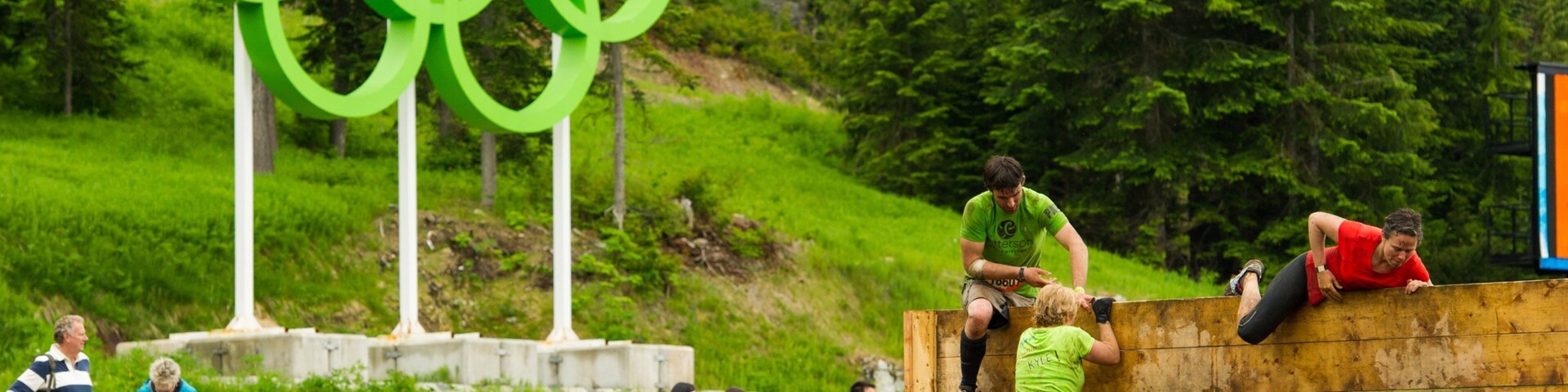 Whistler Olympic Park featuring a sporting event and signage as well as a large group of people