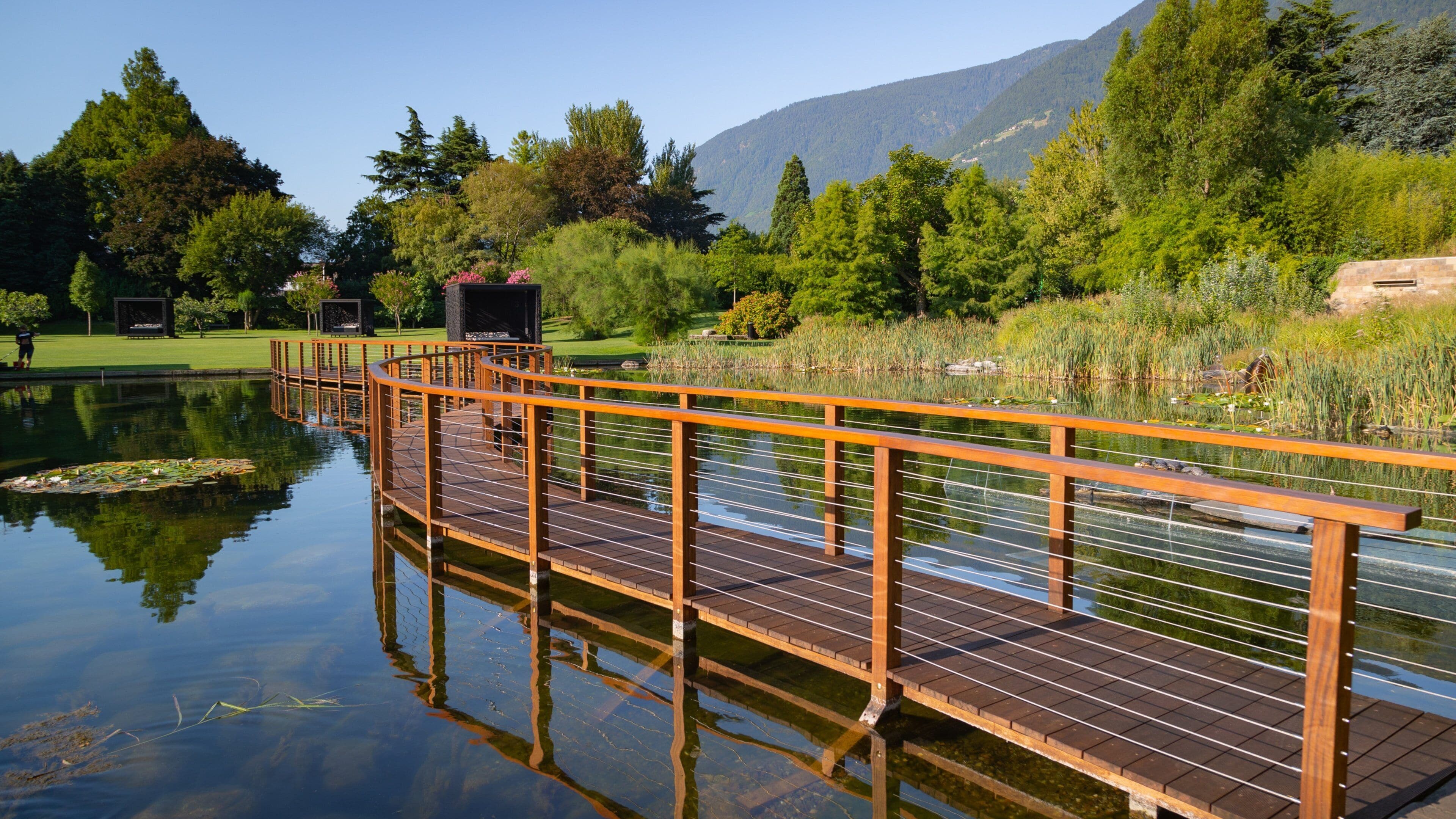 Merano Thermal Baths featuring a bridge and a pond