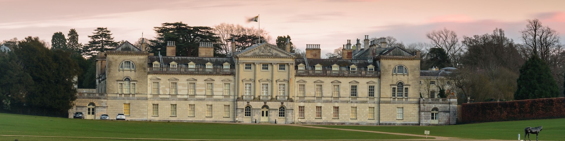 Woburn Abbey, in England, at sunset. Long exposure, blurring the water and clouds