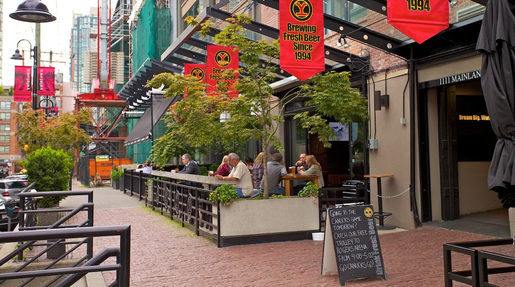 Vibrant street life in Yaletown, Vancouver, showcasing local cafes and outdoor dining along a charming urban walkway