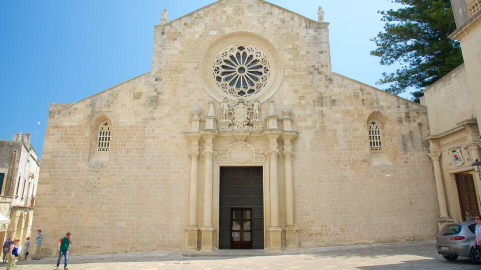 A historic church with a large circular window and a central door.