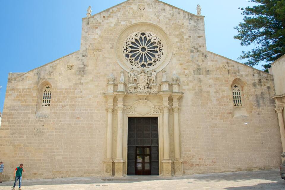 A historic church with a large circular window and a central door.