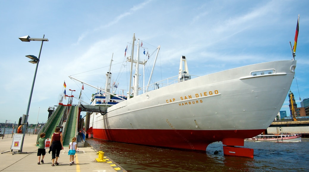 Cap San Diego showing a marina and signage as well as a family