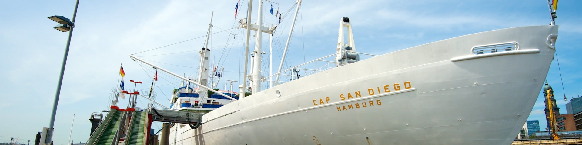 Cap San Diego showing a marina and signage as well as a family