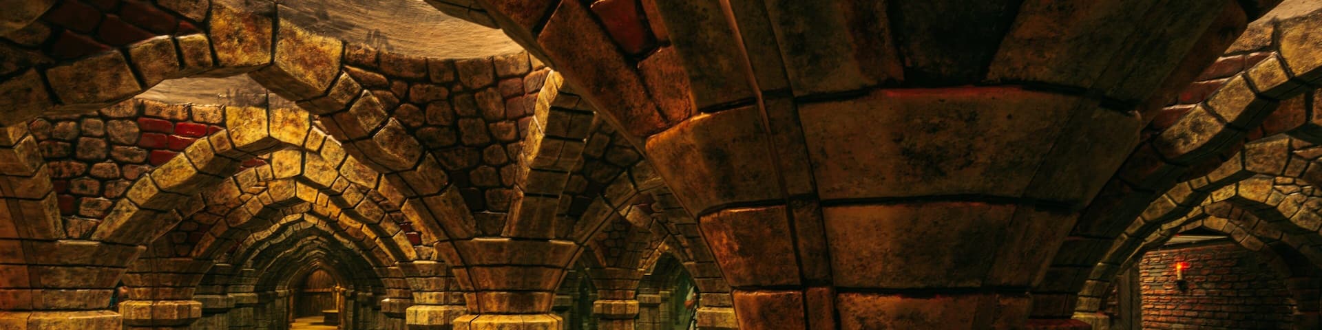 A stone corridor with arches and columns.