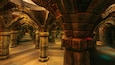 A stone corridor with arches and columns.