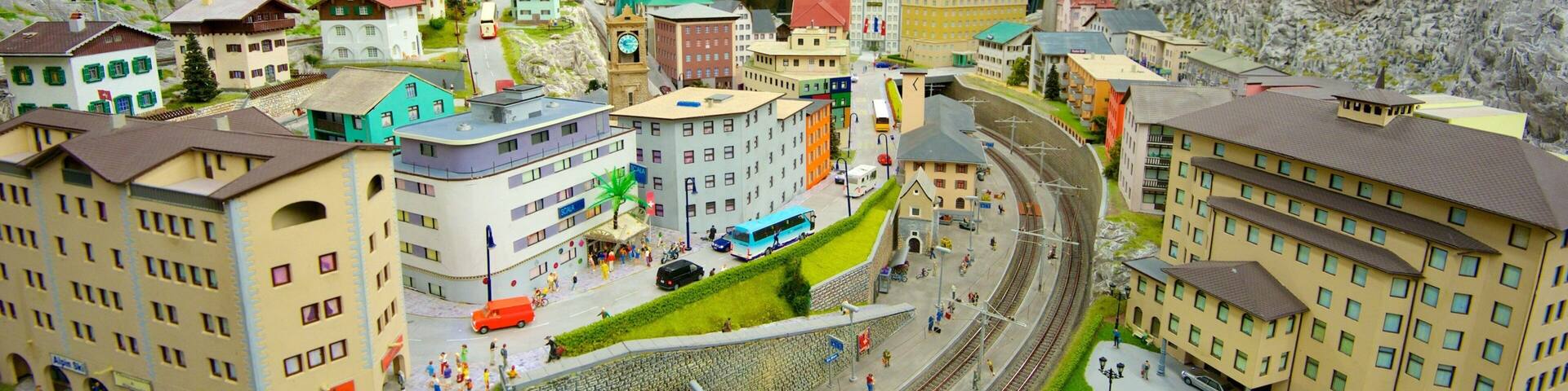 A detailed model of a town with buildings, roads, and a train track.