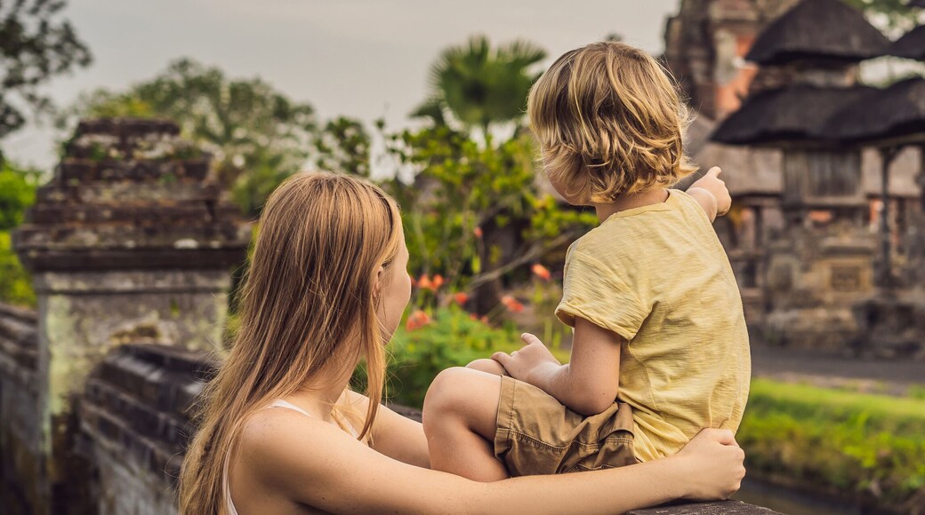Mom and son tourists in Traditional balinese hindu Temple Taman Ayun in Mengwi. Bali, Indonesia Traveling with children concept BANNER, long format