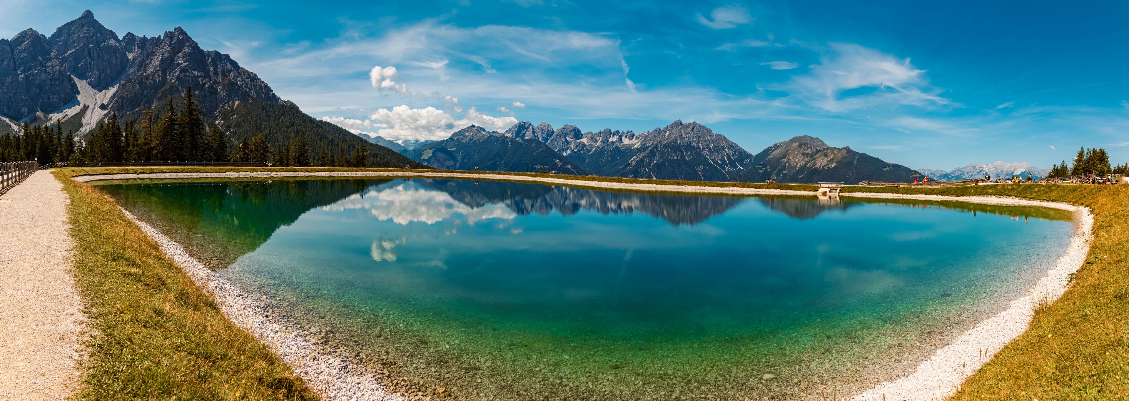 High resolution stitched alpine summer panorama with reflections in a lake at Serles cable car station, Mieders, Stubaital valley, Innsbruck, Austria