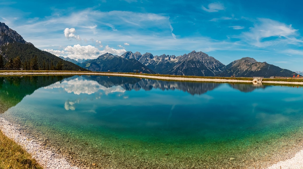 High resolution stitched alpine summer panorama with reflections in a lake at Serles cable car station, Mieders, Stubaital valley, Innsbruck, Austria