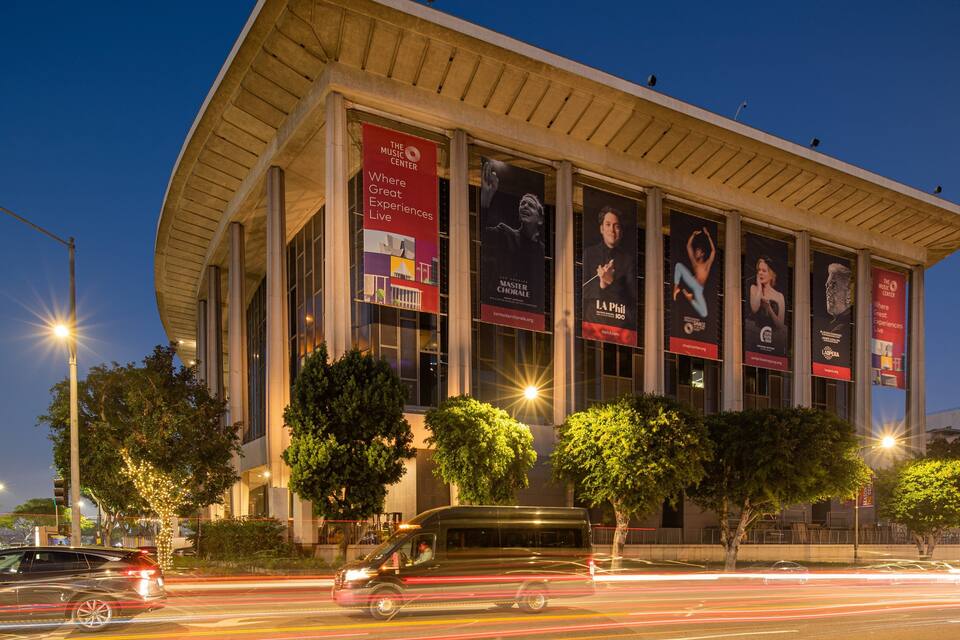 A modern building with large posters advertising events.