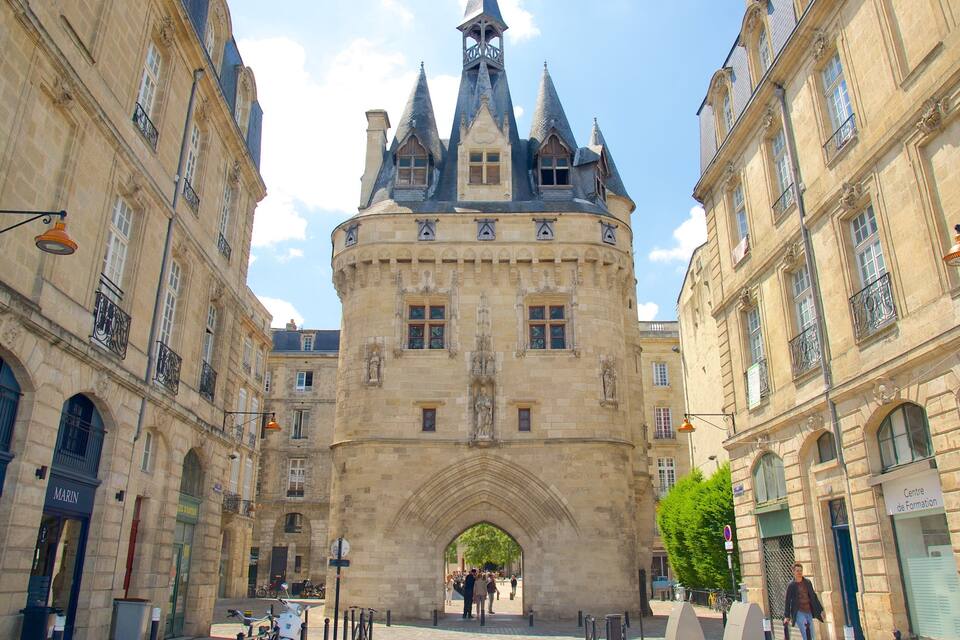 A historic building with a pointed tower and arched entrance.