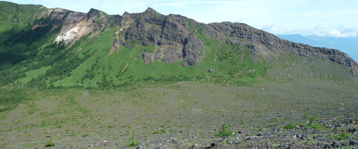 A mountainous landscape with rocky terrain and sparse vegetation.