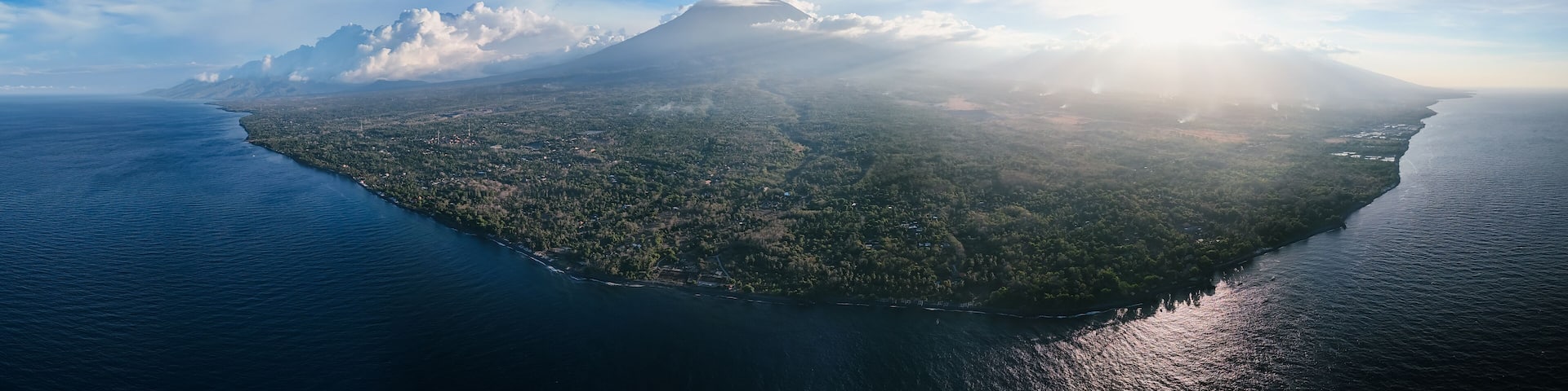 Panoramic view of coastline with volcano and in Bali
