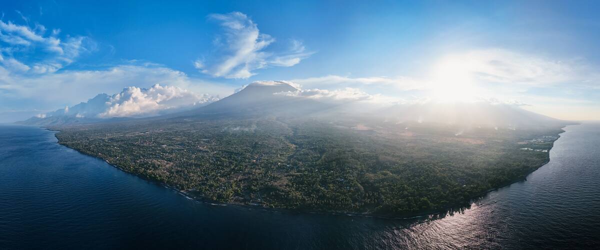 An island with a mountain, surrounded by water.