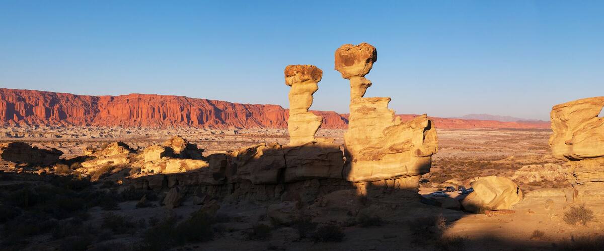 Rock formations in a desert landscape with a clear sky.