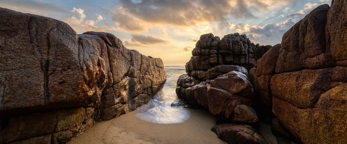 A rocky coastline with waves crashing against the shore.