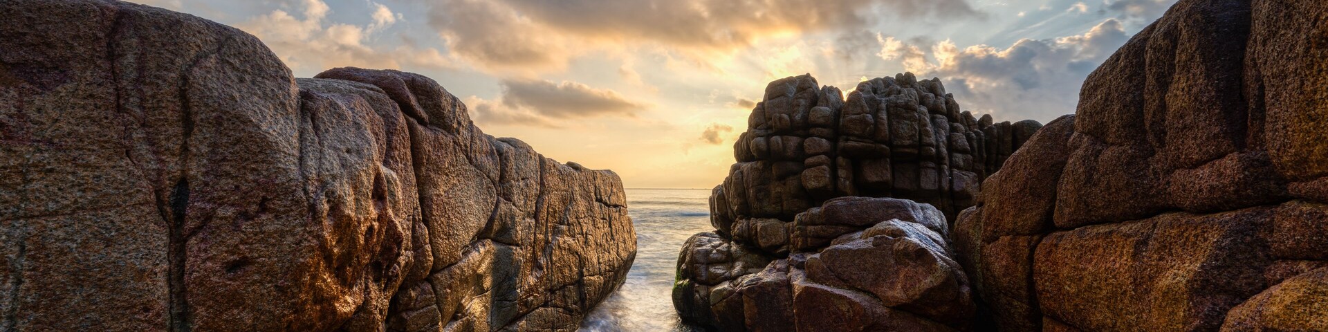 A rocky coastline with waves crashing against the shore.