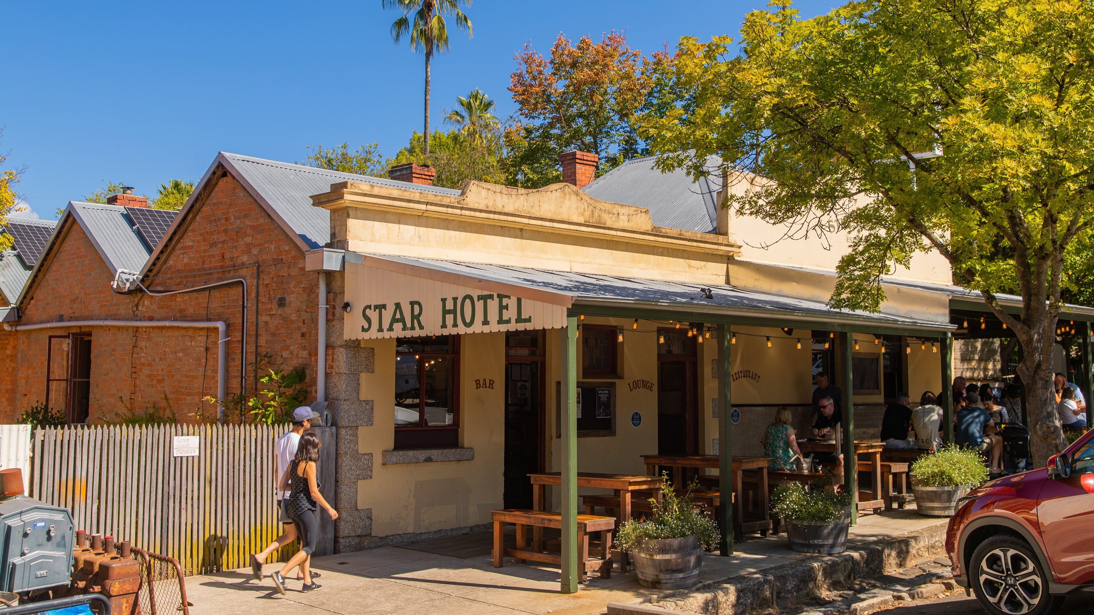 A Star Hotel with outdoor seating and a bar/lounge area.